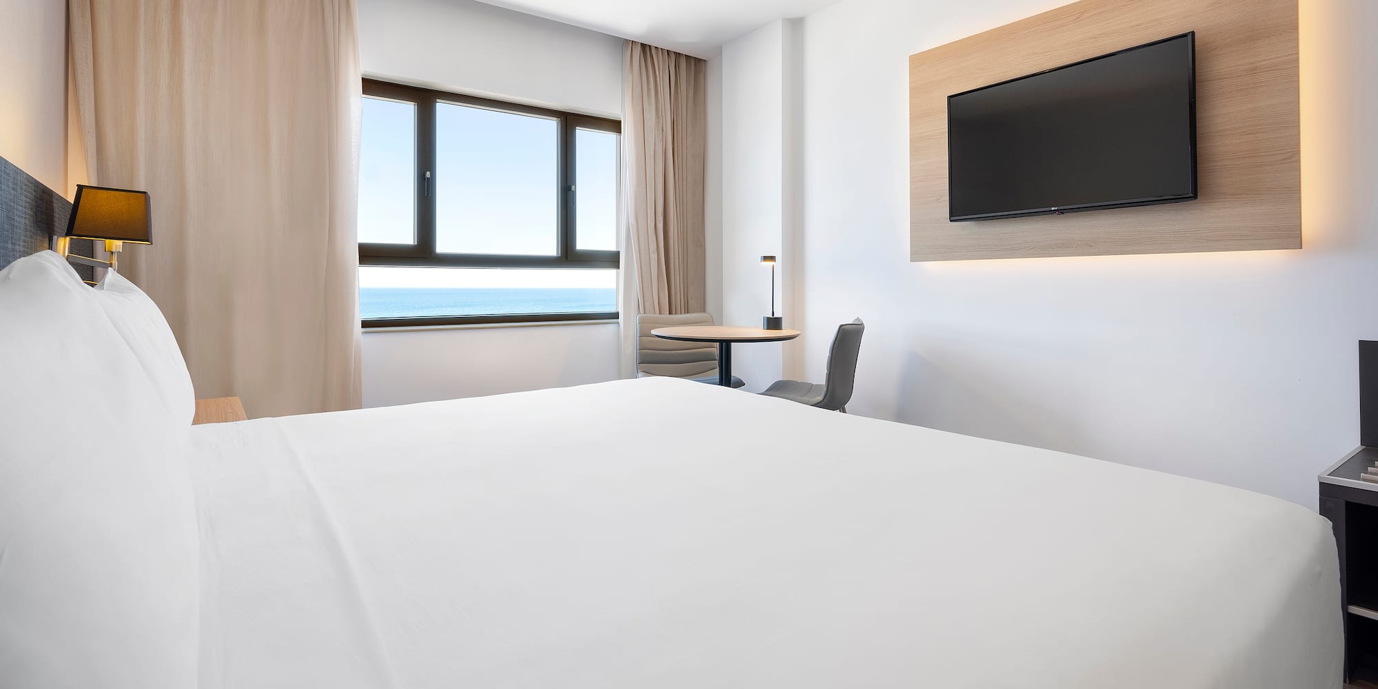 a room with a bed and a television