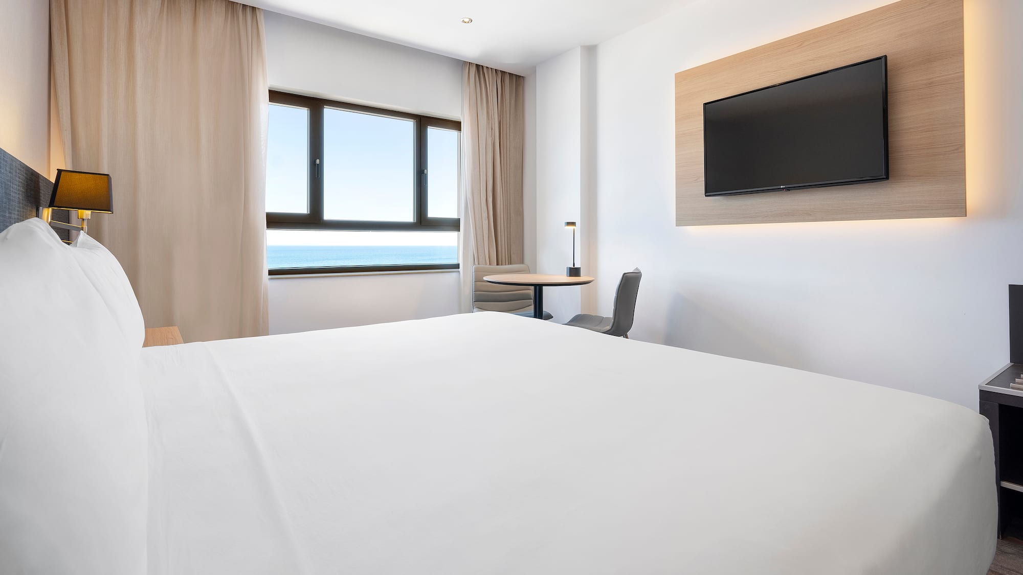 a room with a bed and a television