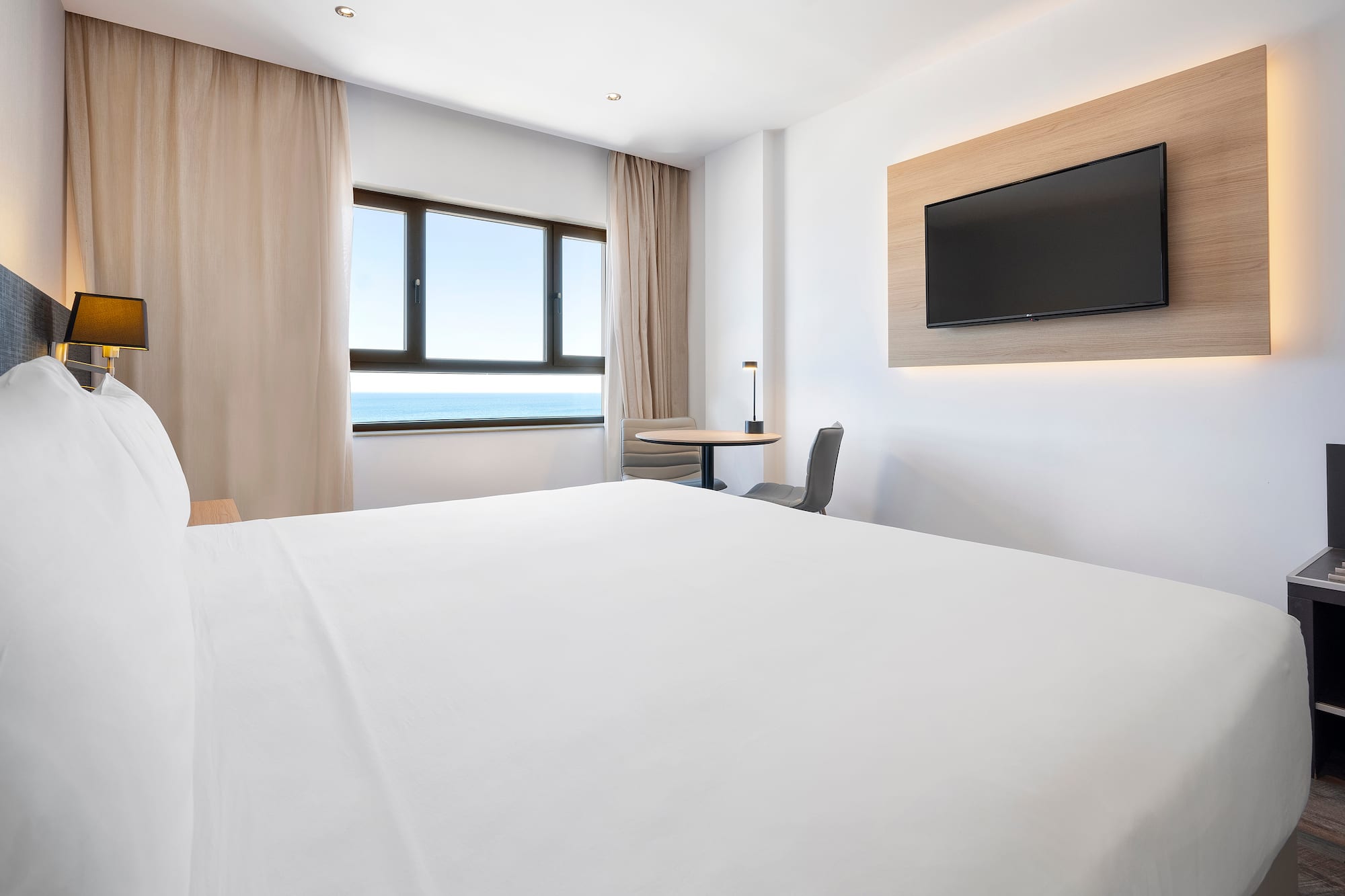 a room with a bed and a television