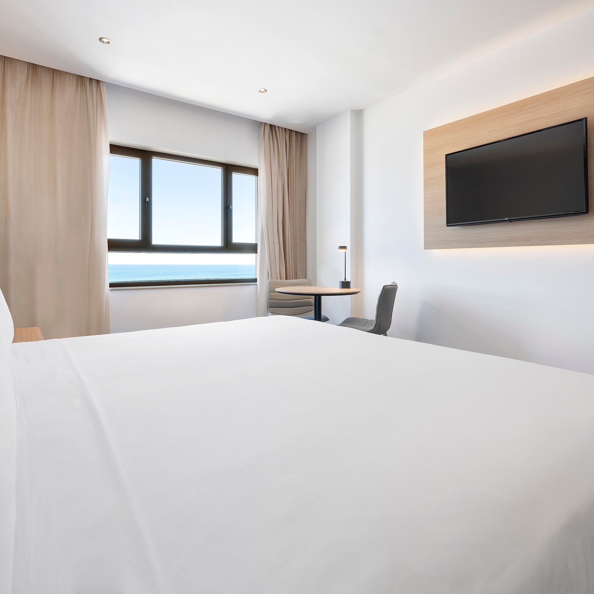 a room with a bed and a television