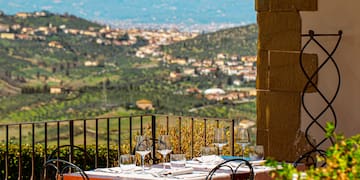 a table and chairs outside with a view of a valley in the background