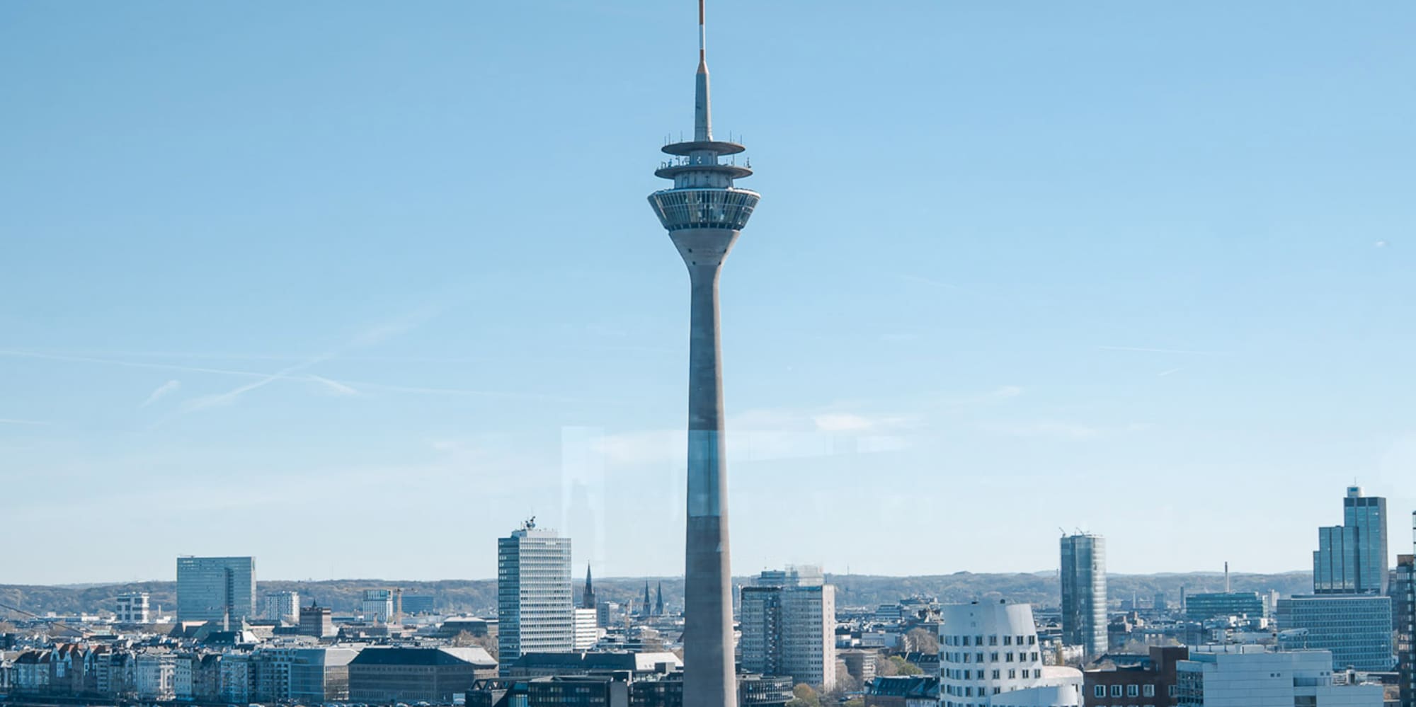 Düsseldorf Rheinturm, Media Harbour, and city skyline along the Rhine River.