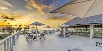 a deck with chairs and umbrellas on a sunny day