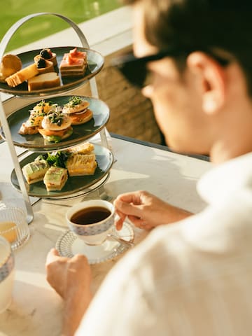 a man sitting at a table with a tray of food