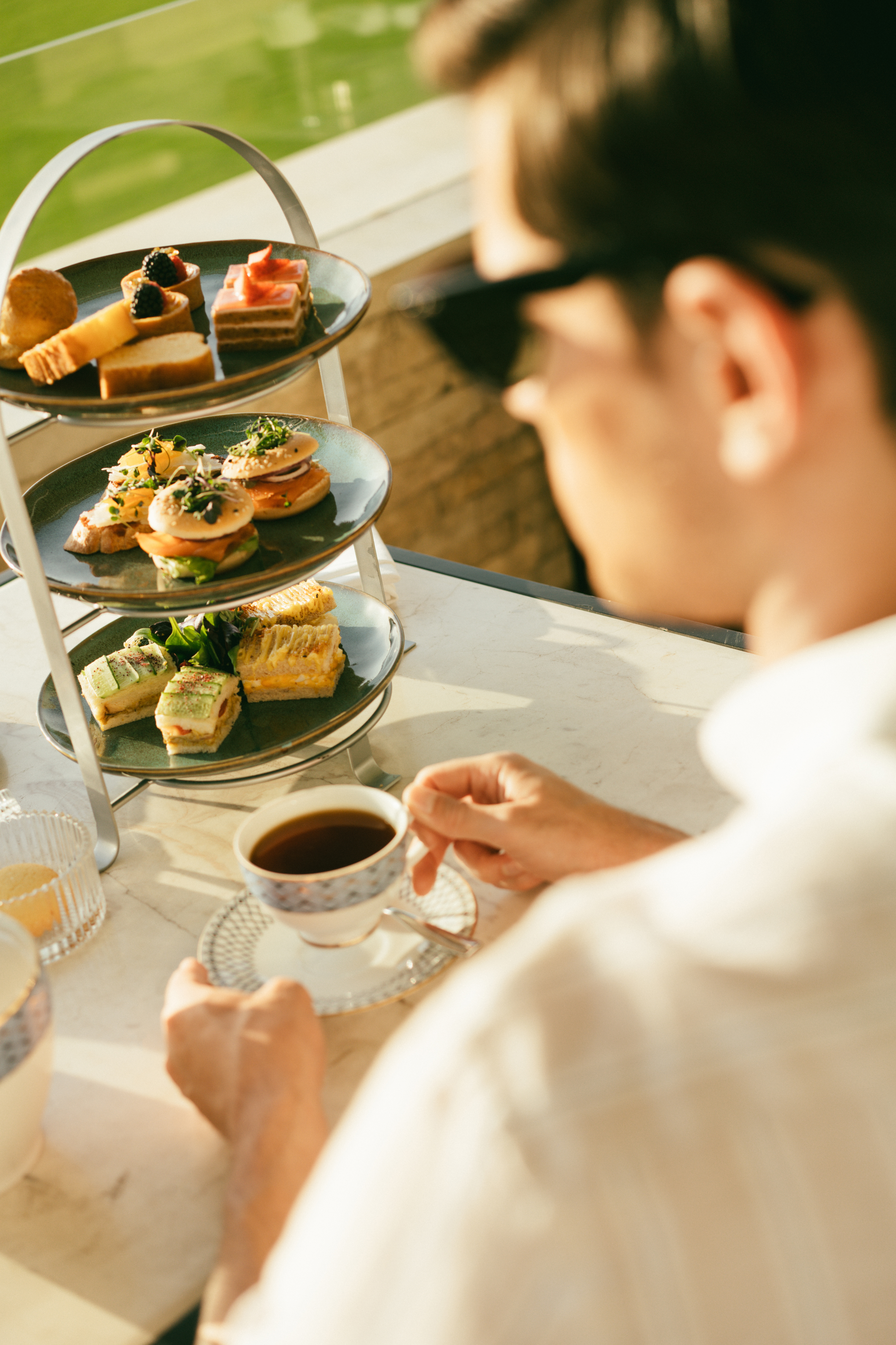 a man sitting at a table with a tray of food