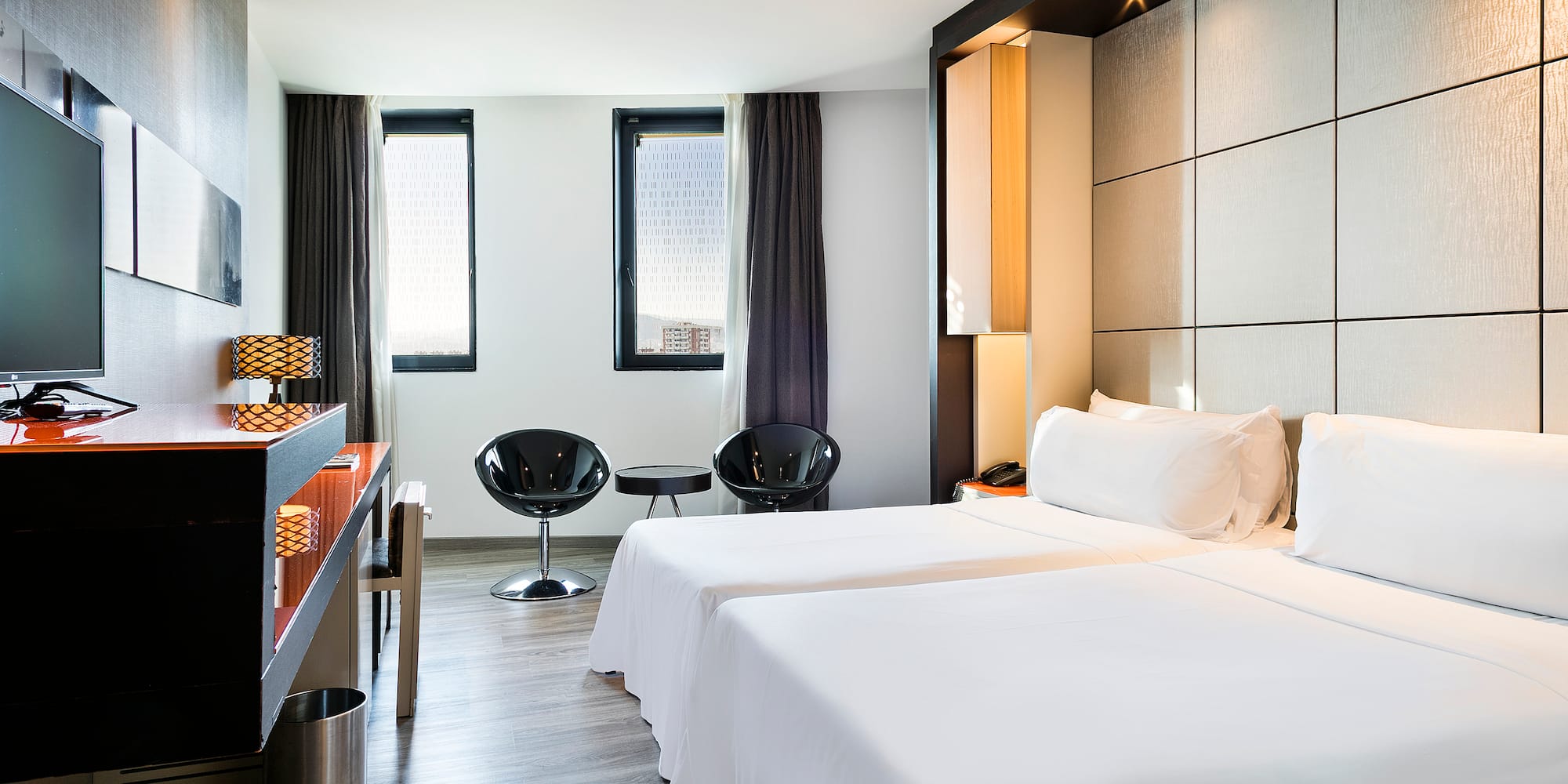 a room with two beds and a table