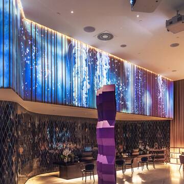 a room with a colorful wall and a large column