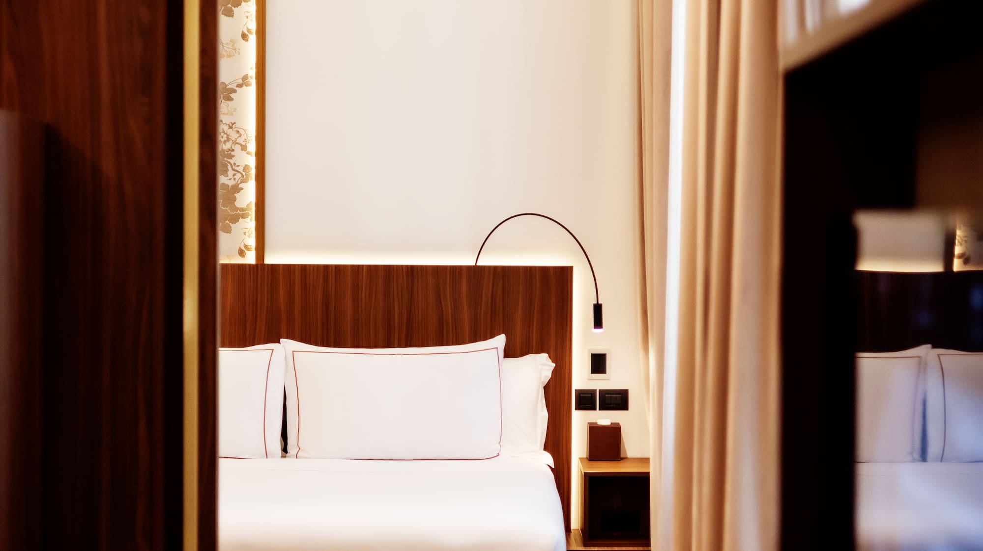 a room with a bed and a bookcase