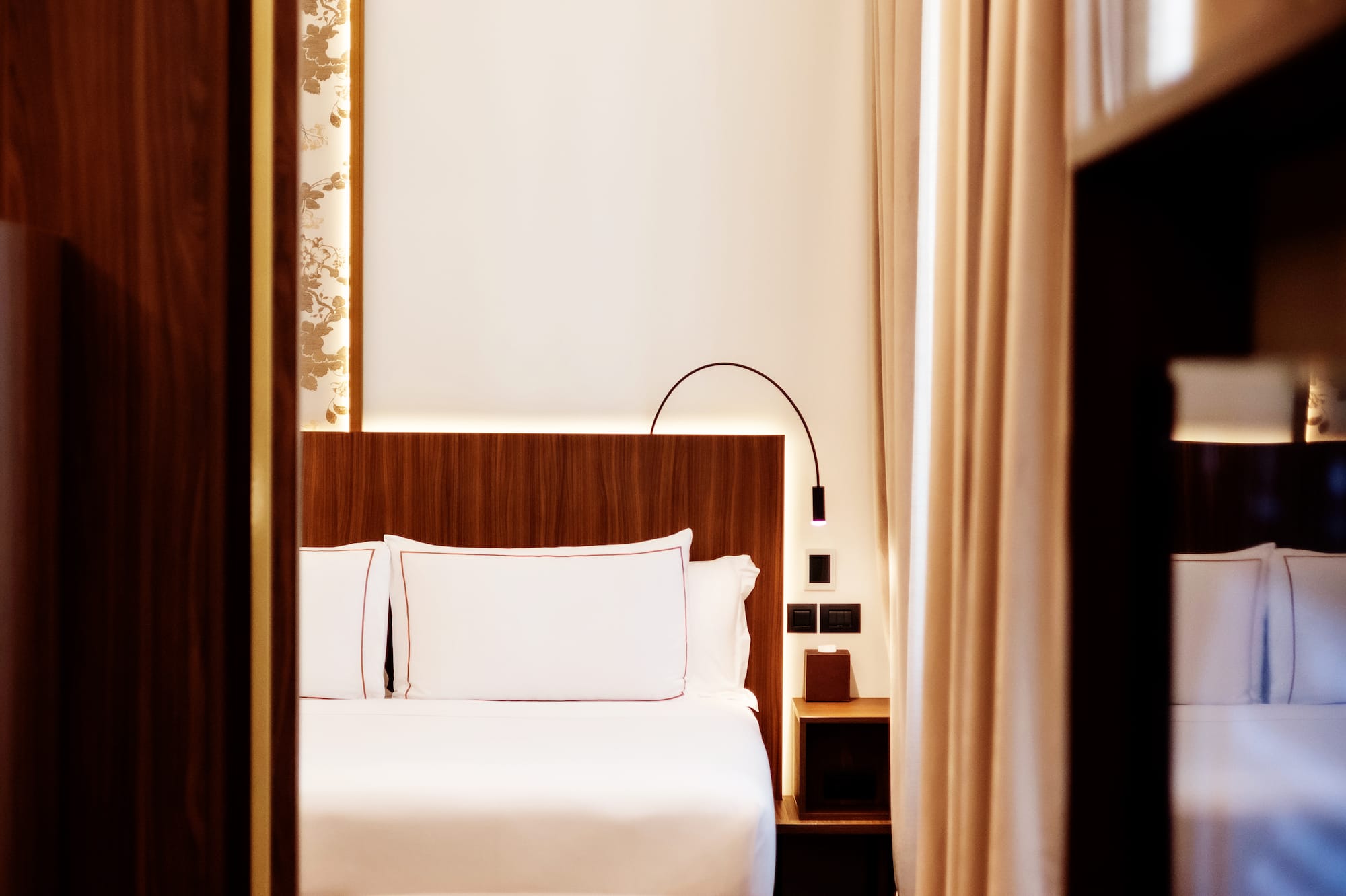 a room with a bed and a bookcase