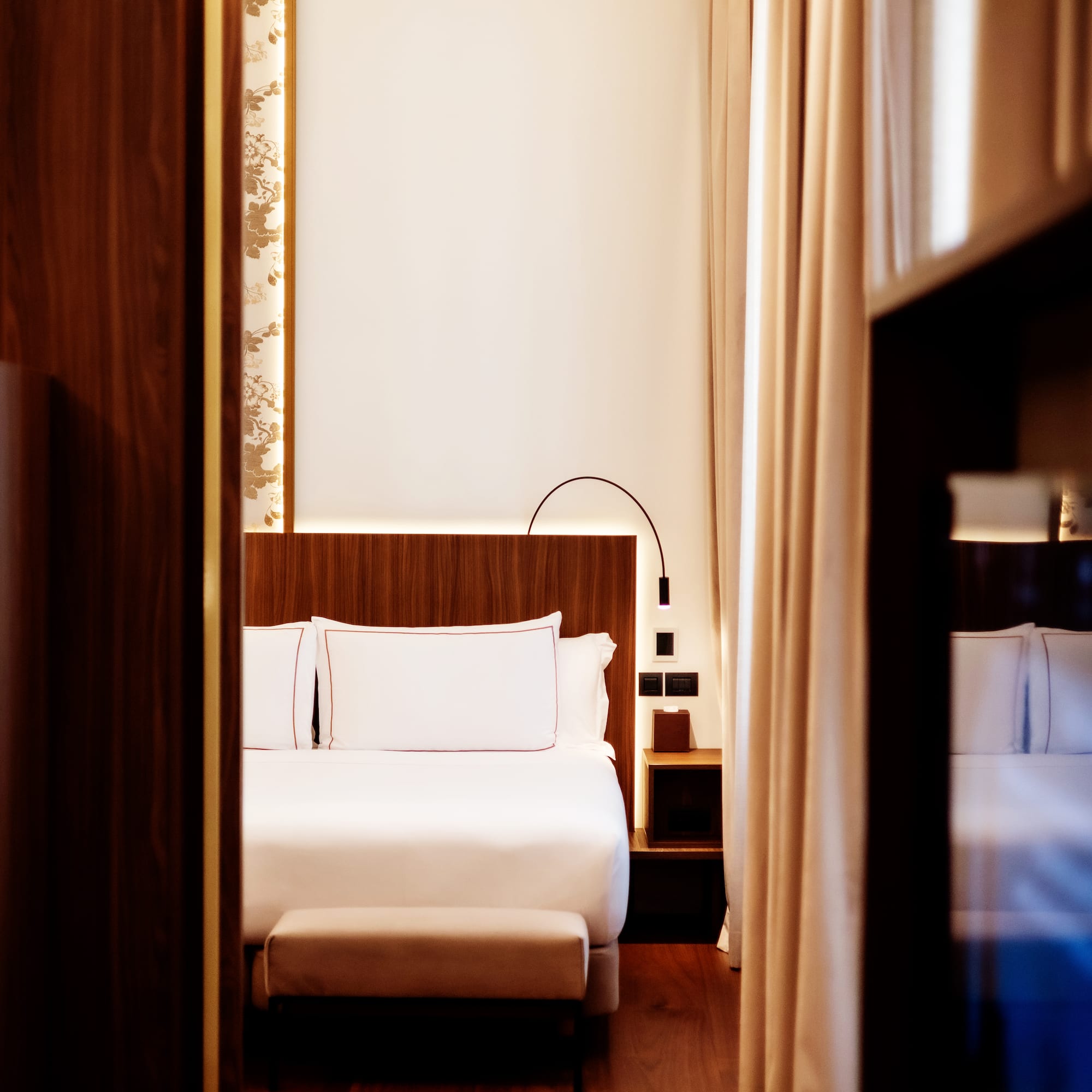 a room with a bed and a bookcase