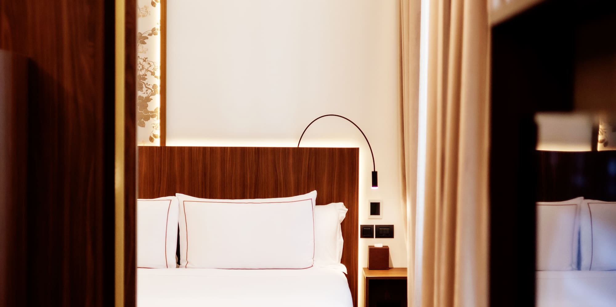 a room with a bed and a bookcase