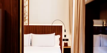 a room with a bed and a bookcase