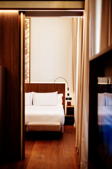 a room with a bed and a bookcase