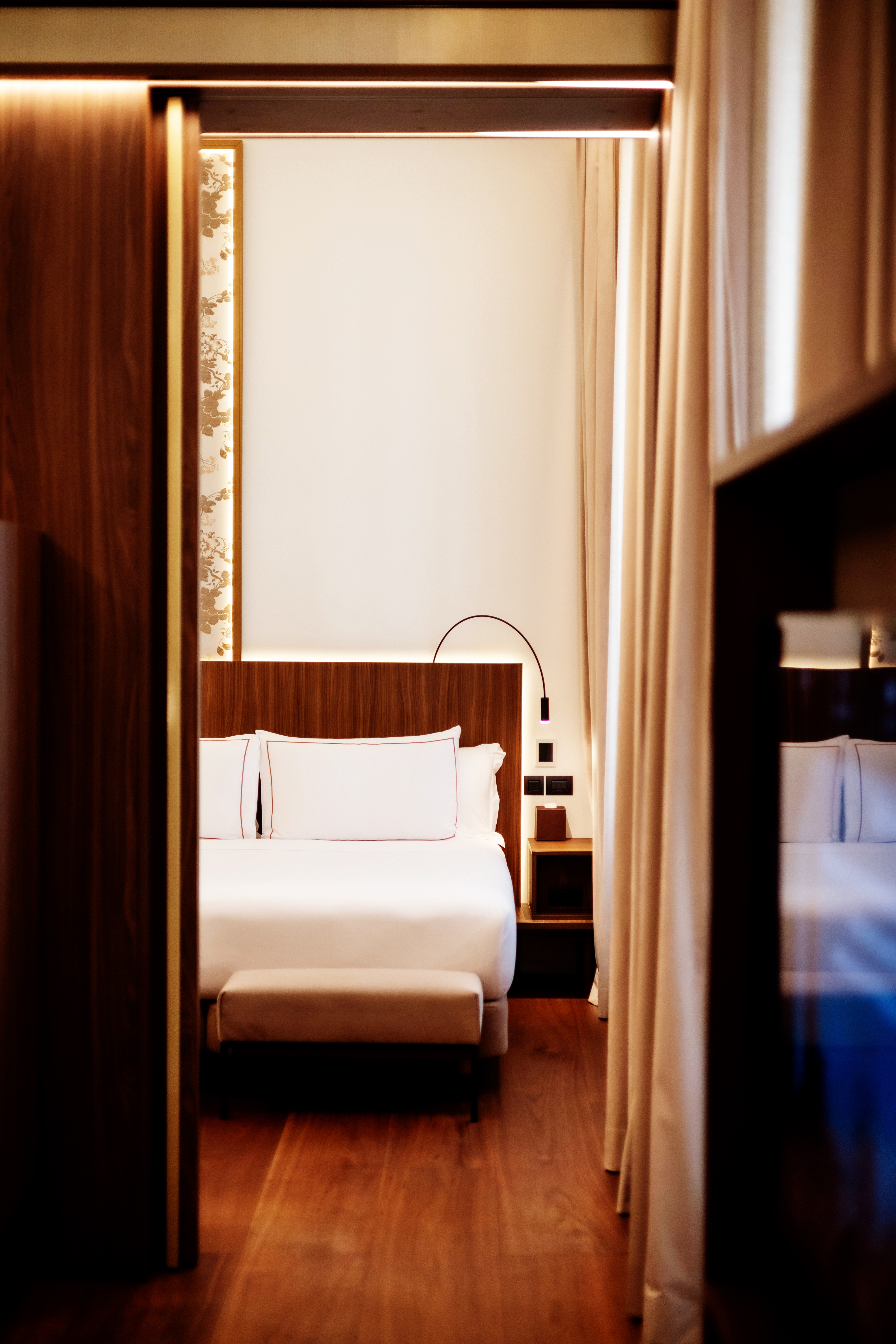 a room with a bed and a bookcase