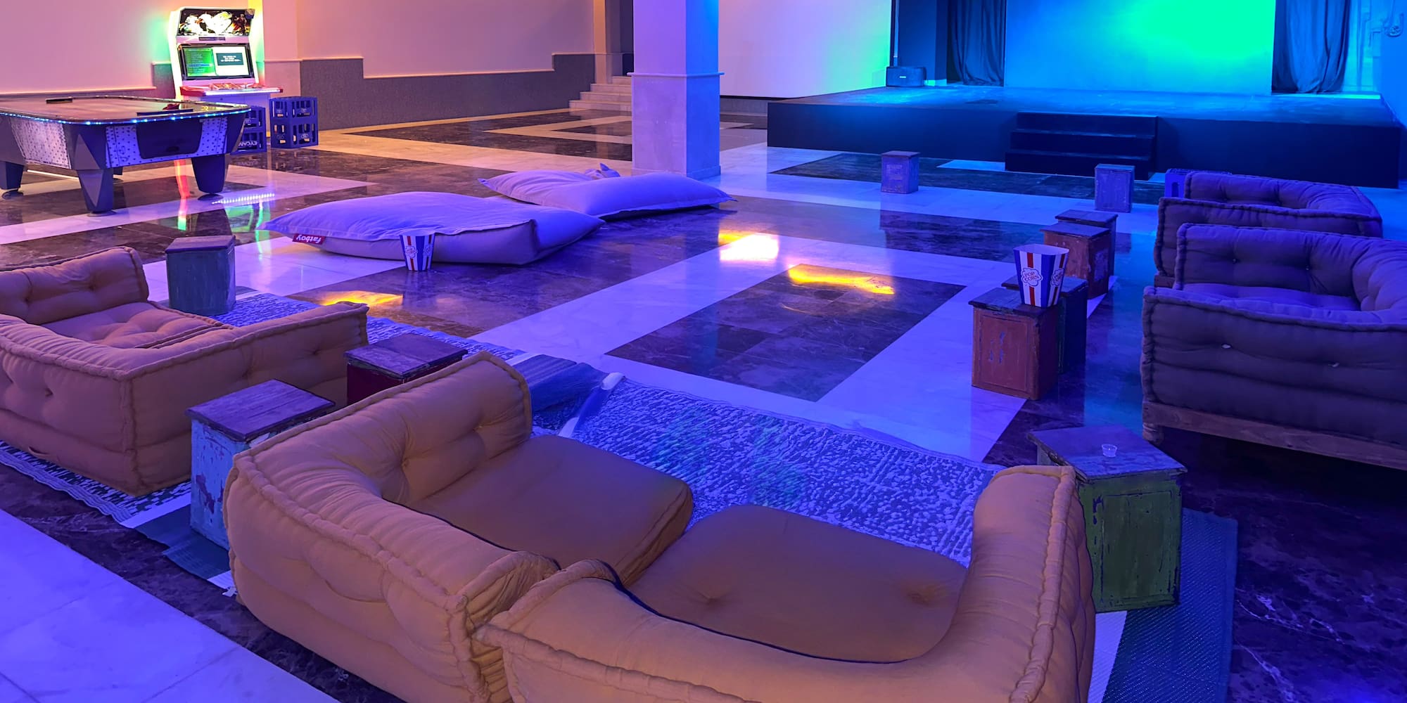 a large room with couches and a stage