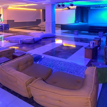 a large room with couches and a stage