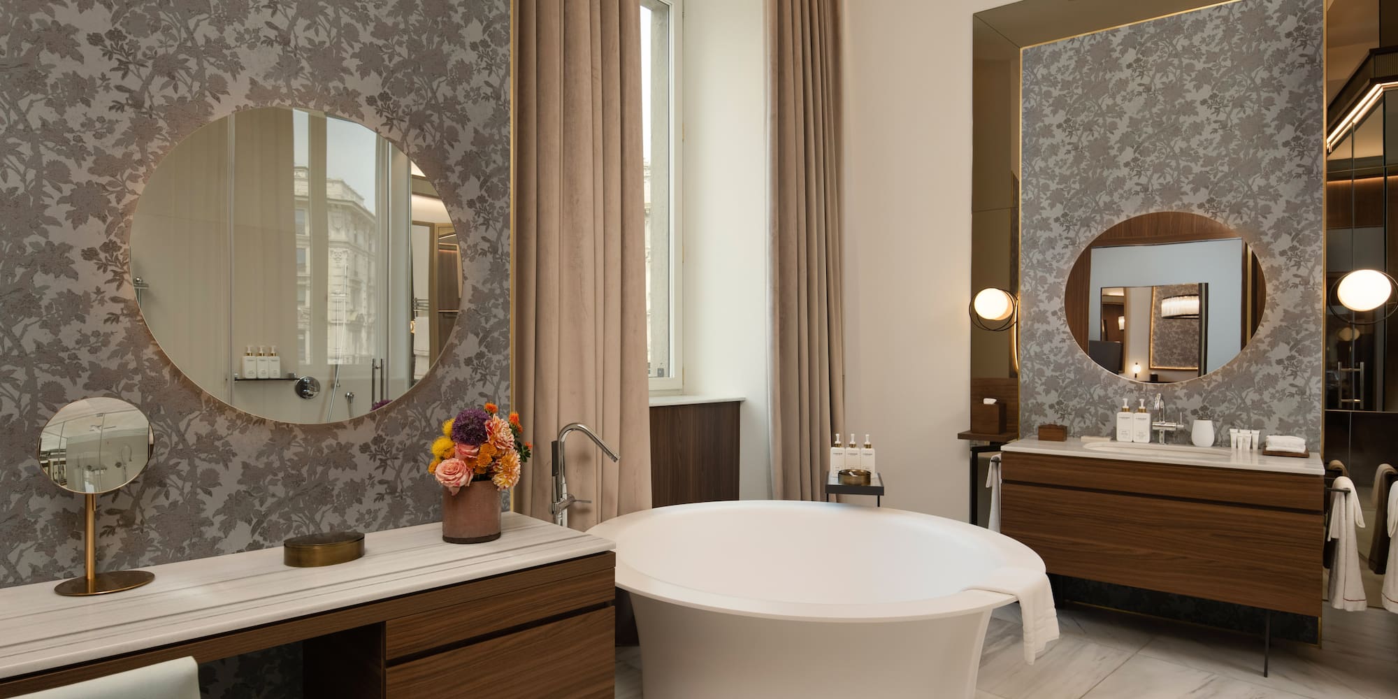 Luxury bathroom with modern freestanding tub, marble, and patterned walls.