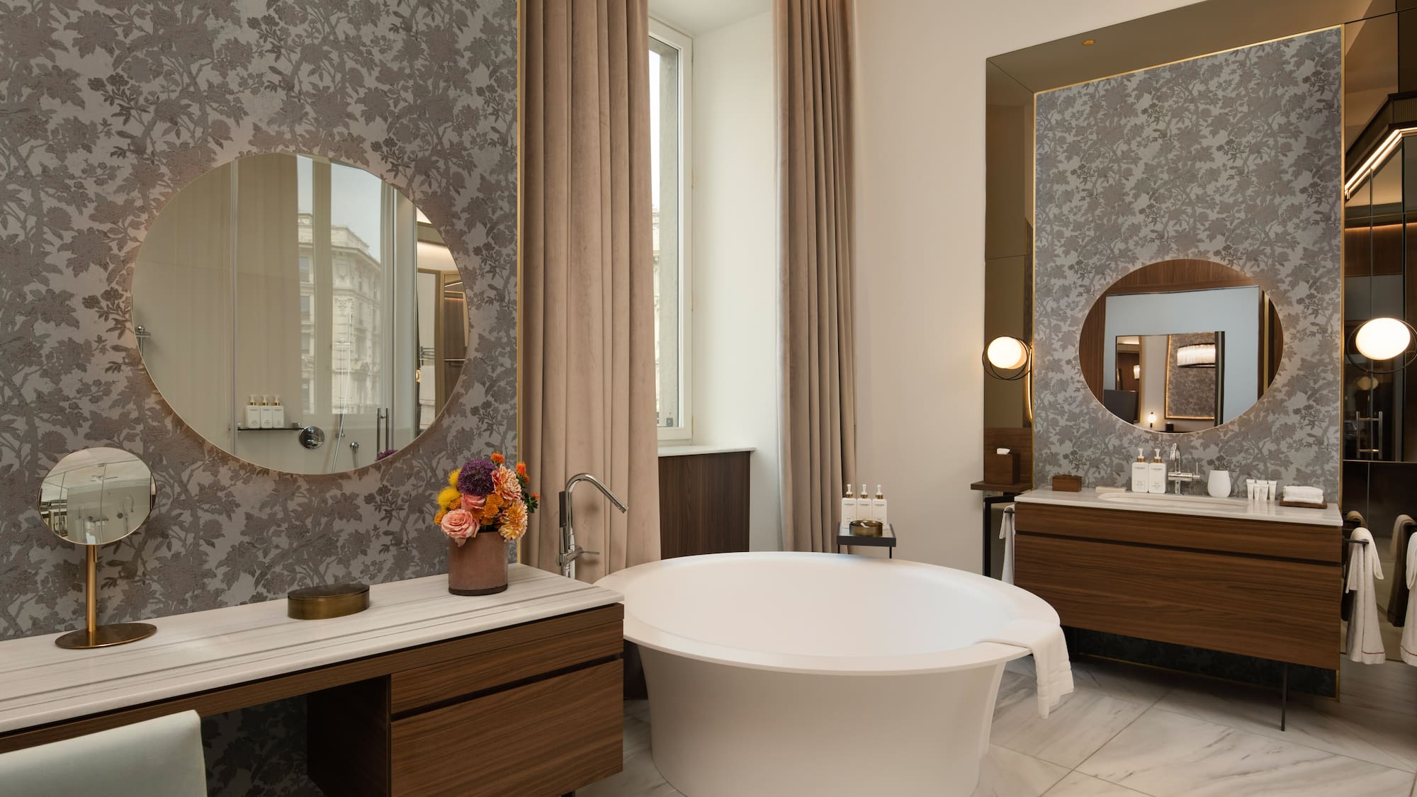 Luxury bathroom with modern freestanding tub, marble, and patterned walls.