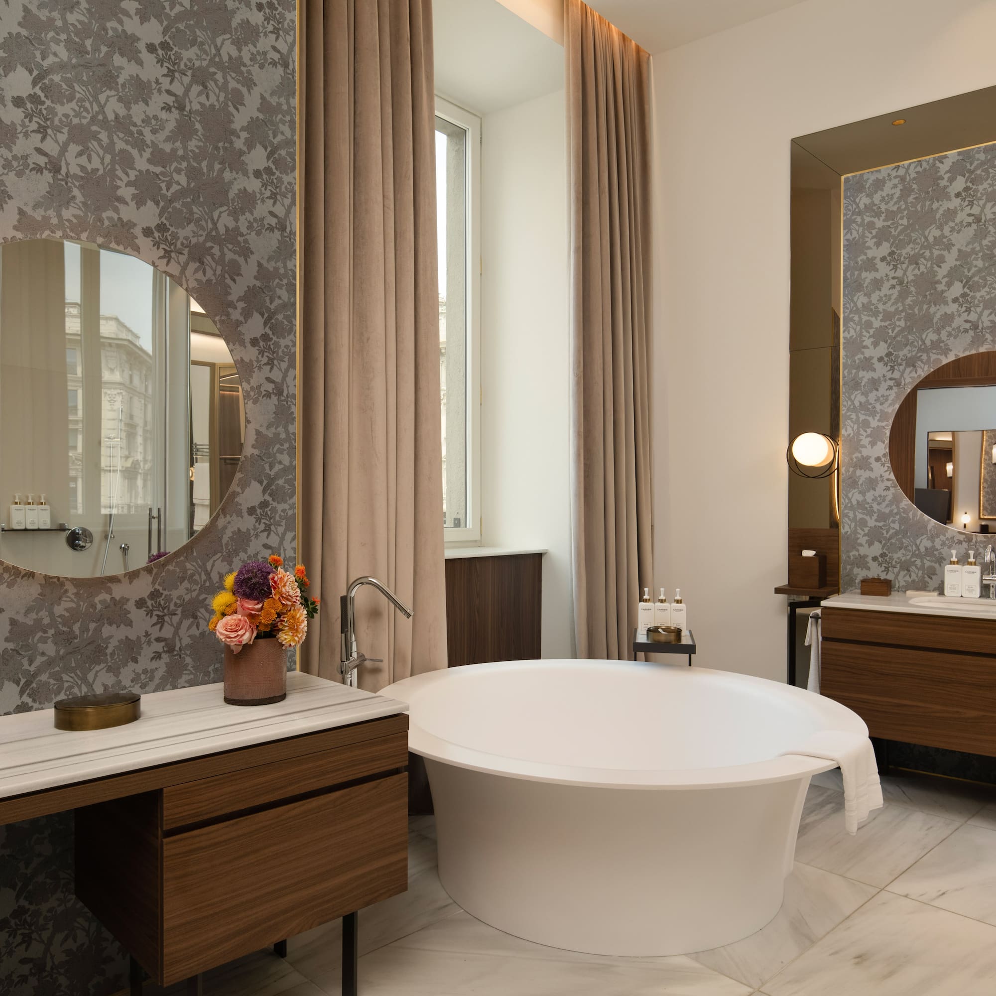 Luxury bathroom with modern freestanding tub, marble, and patterned walls.