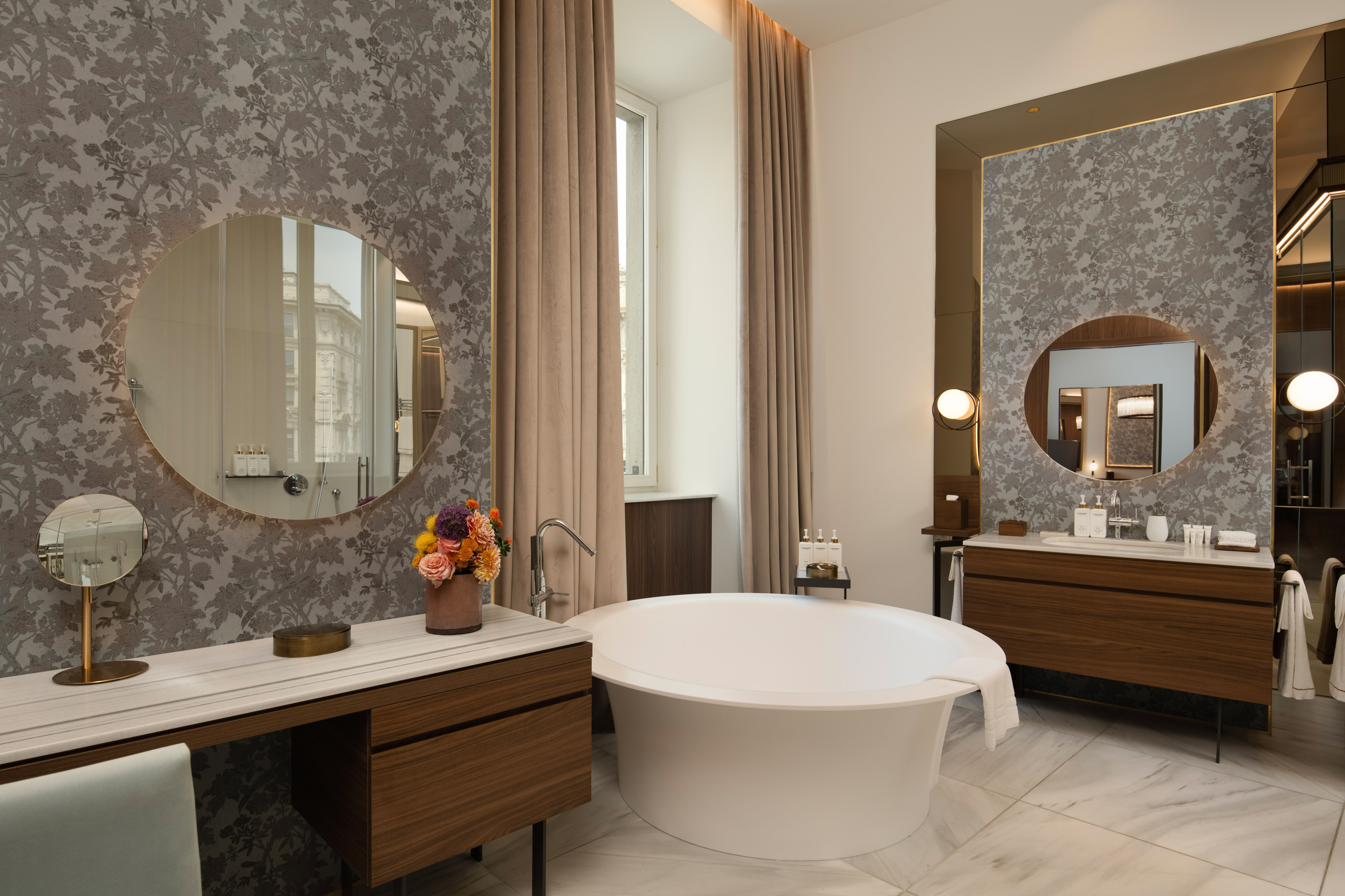 Luxury bathroom with modern freestanding tub, marble, and patterned walls.