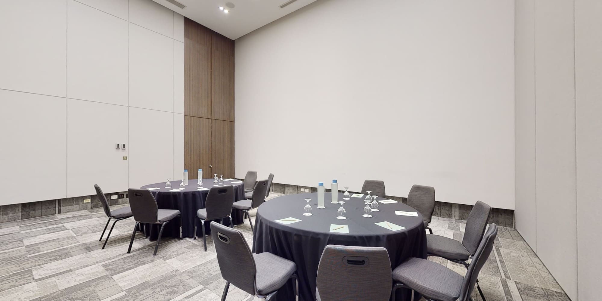 a room with round tables and chairs