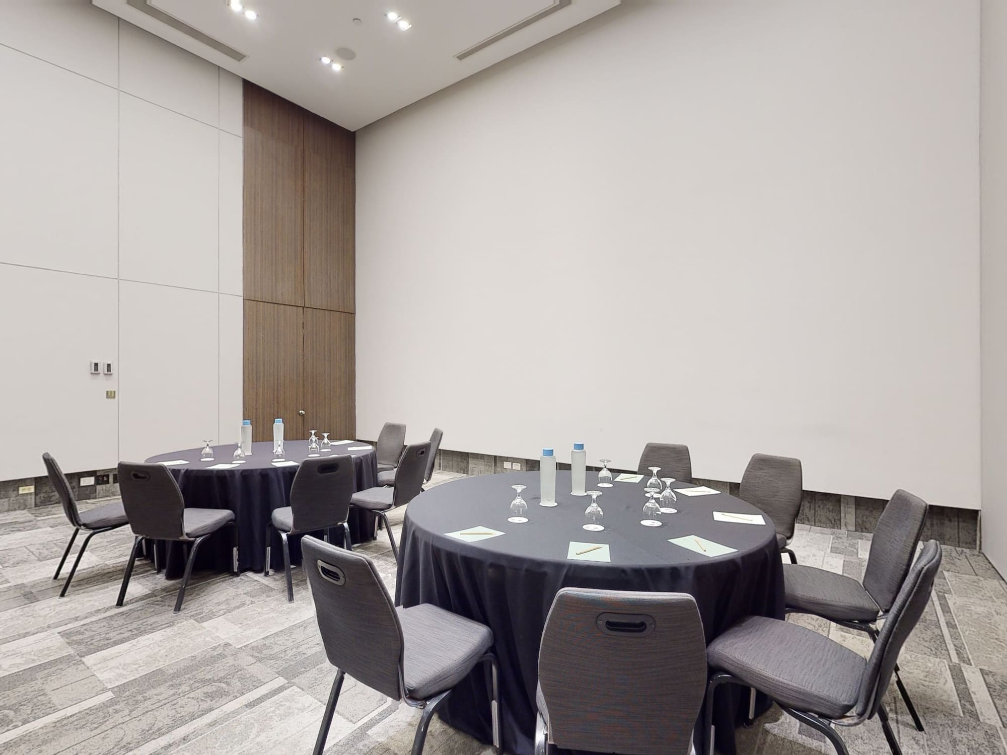 a room with round tables and chairs