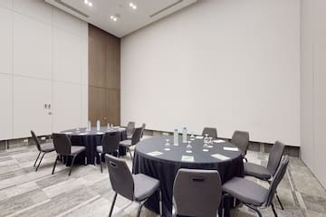 a room with round tables and chairs