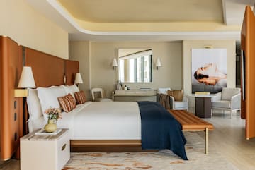 a bedroom with a bed and a chair