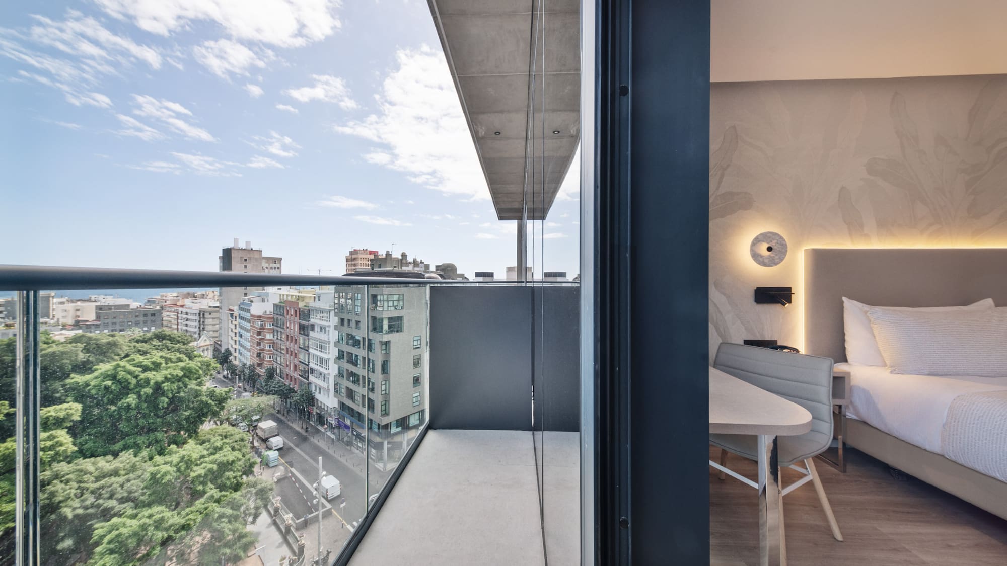 a balcony with a table and chairs and a view of a city