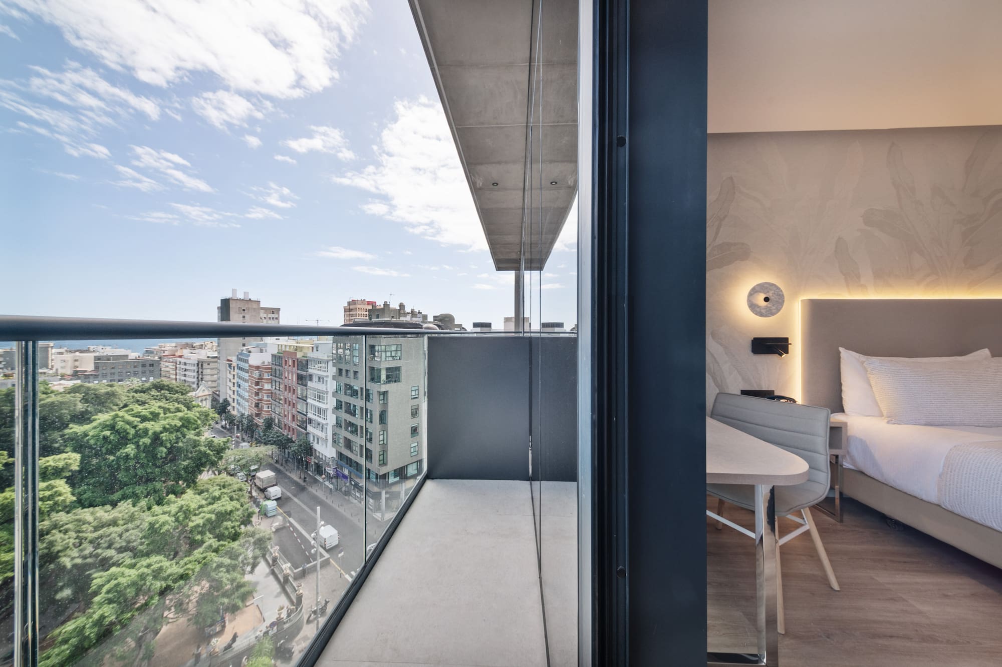 a balcony with a table and chairs and a view of a city