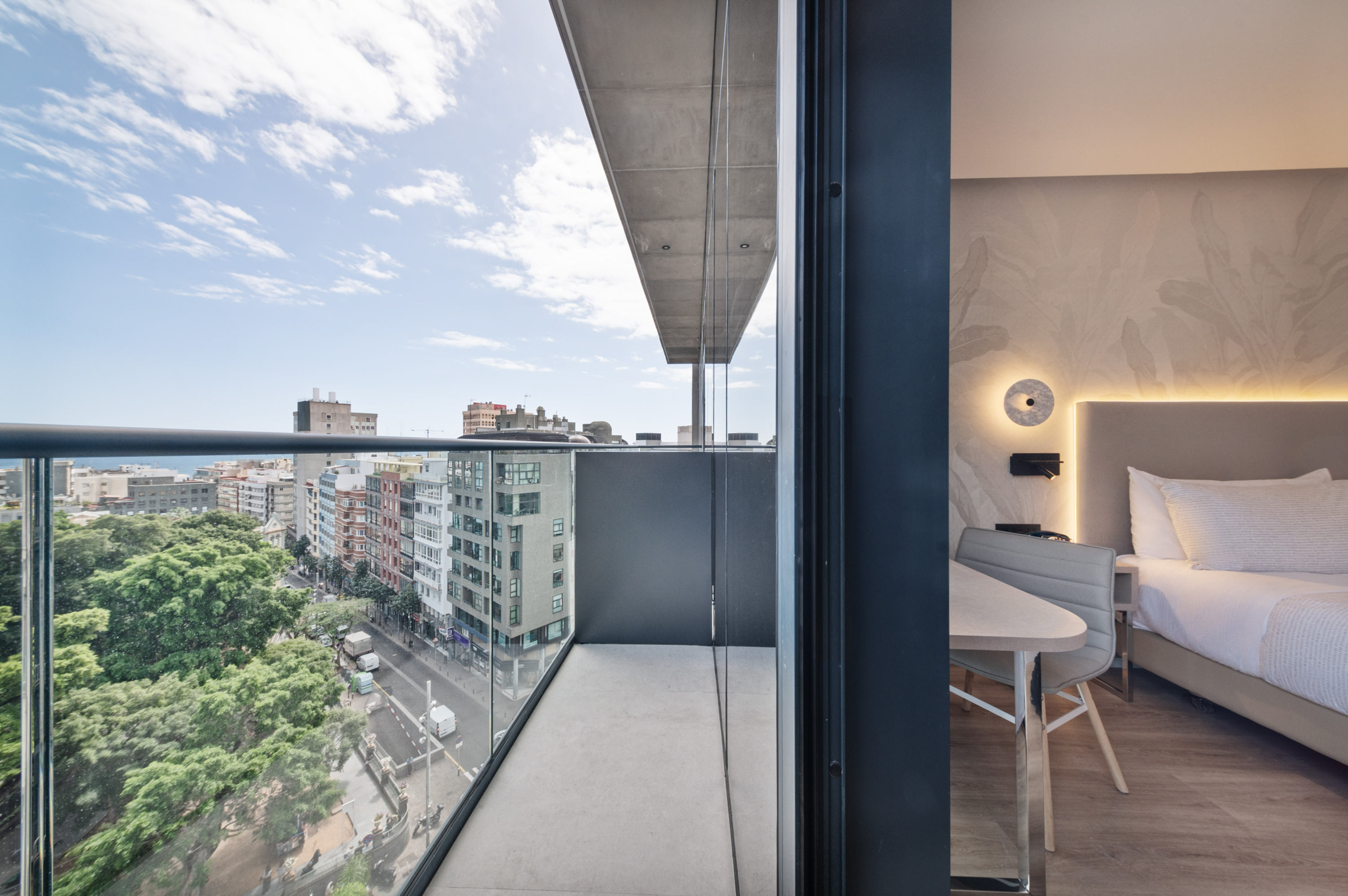 a balcony with a table and chairs and a view of a city