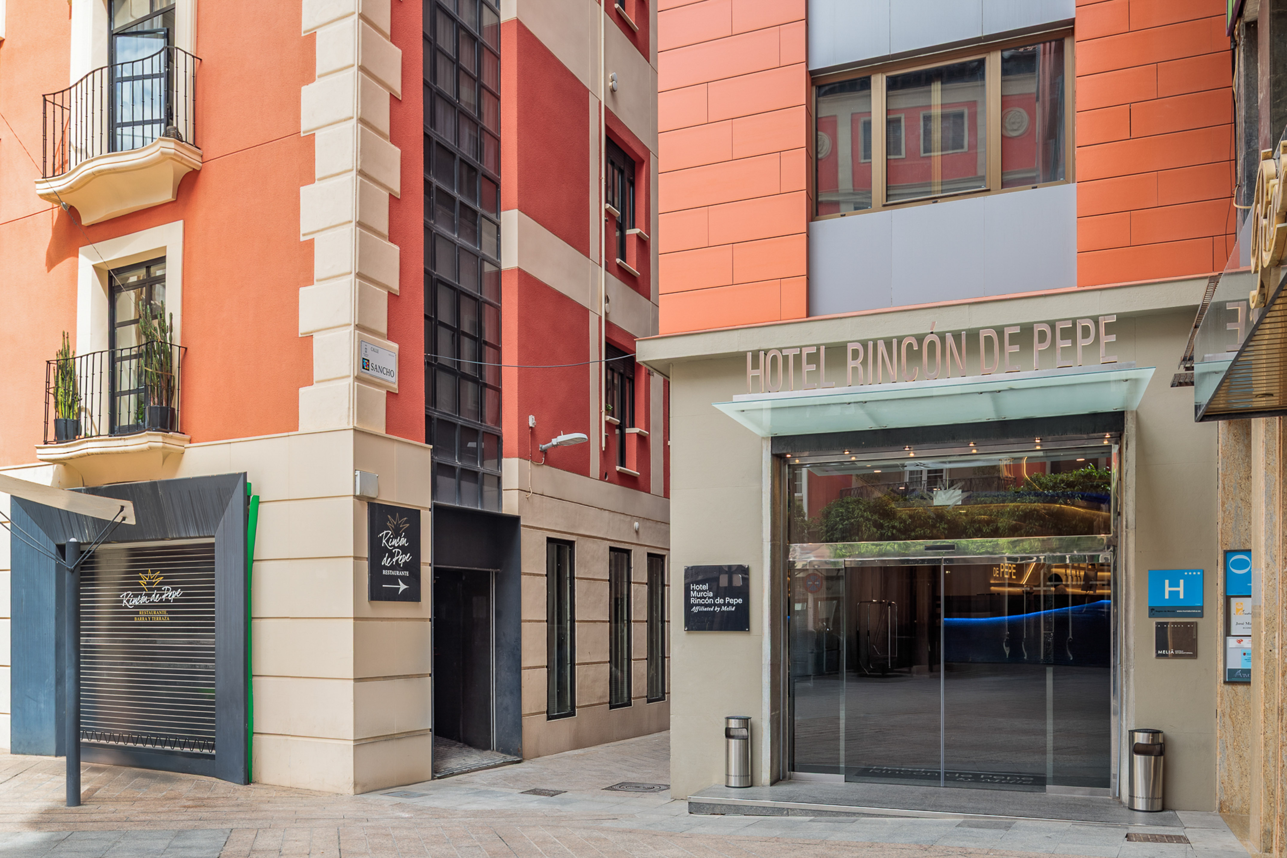 Hotel Murcia Rincón de Pepe entrance, orange building, Melia affiliated.