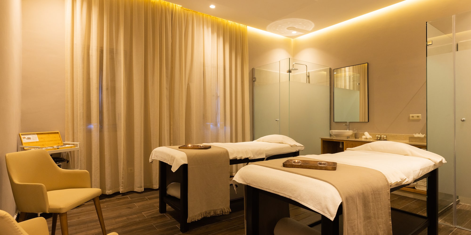 a massage room with beds and a shower