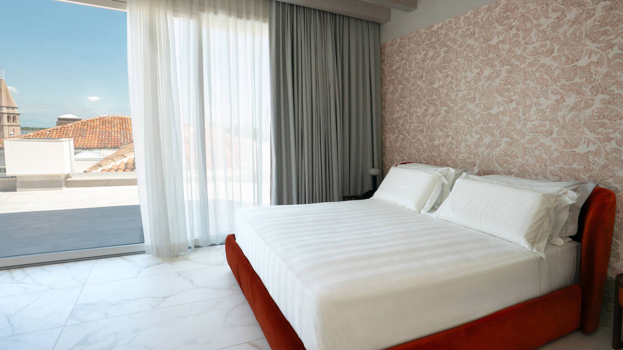 a bed in a room with a glass door