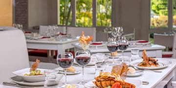 a table with plates of food and glasses of wine