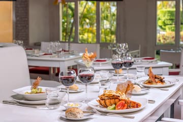 a table with plates of food and glasses of wine