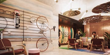 a man sitting on a couch with a bicycle on the wall