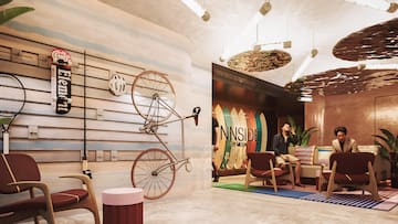 a man sitting on a couch with a bicycle on the wall