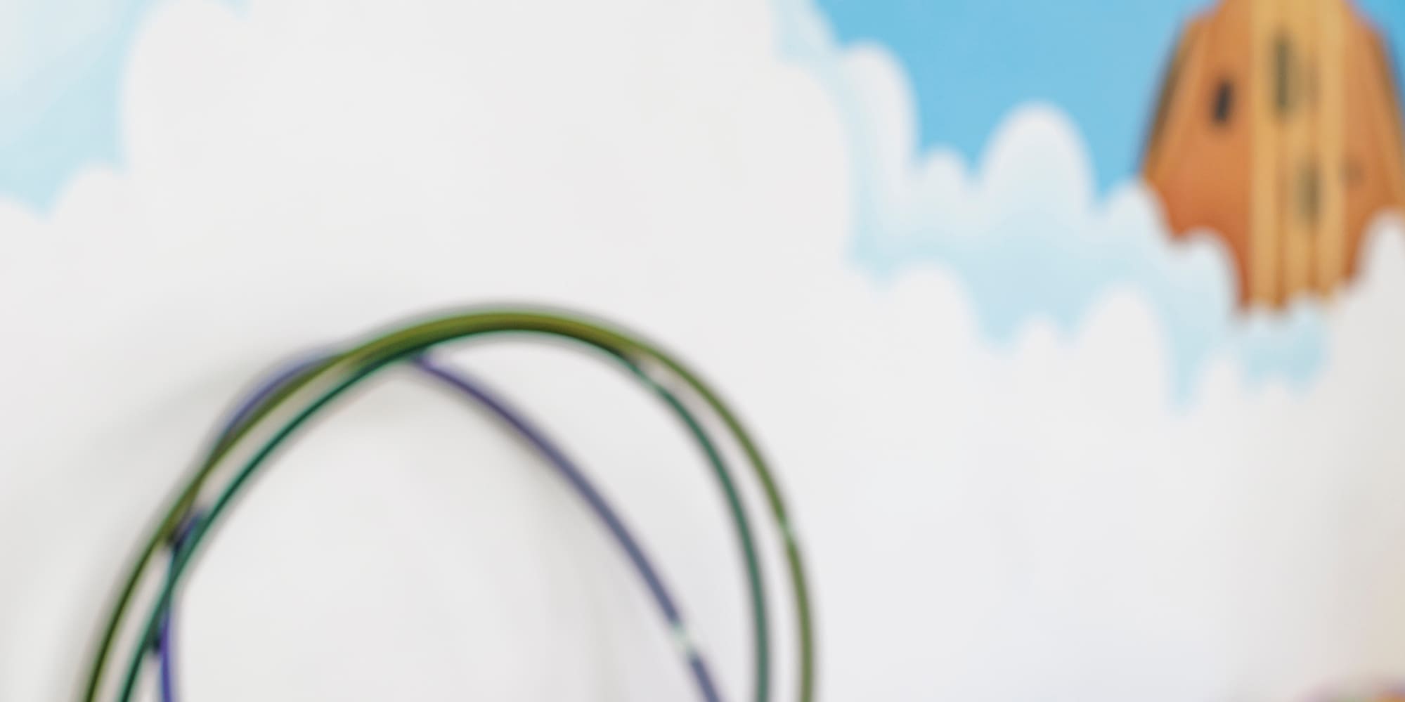 a room with a wall mural and a toy box