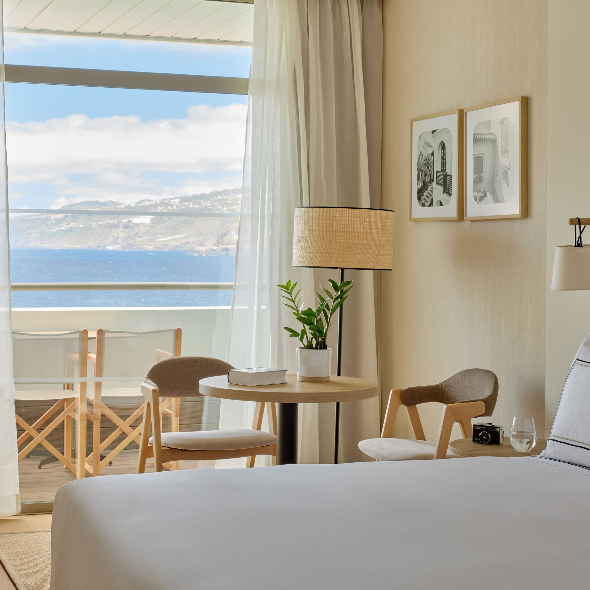 a room with a bed and chairs and a table and chairs