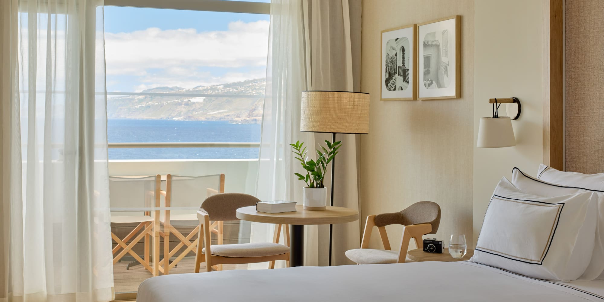 a room with a bed and chairs and a table and chairs