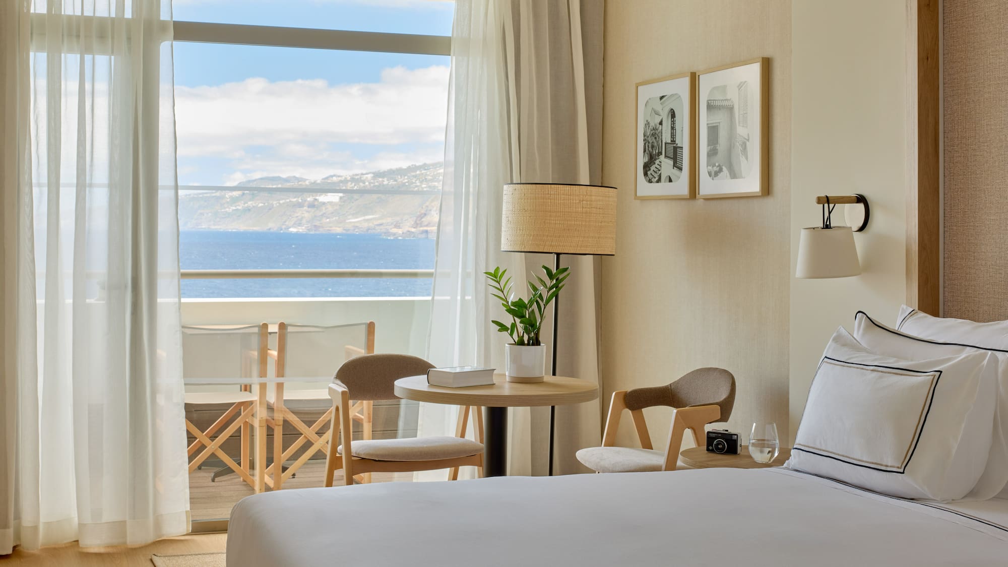 a room with a bed and chairs and a table and chairs