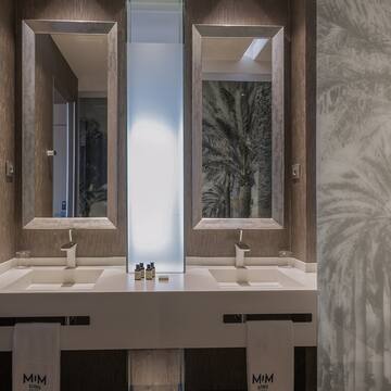 a bathroom with two sinks and mirrors