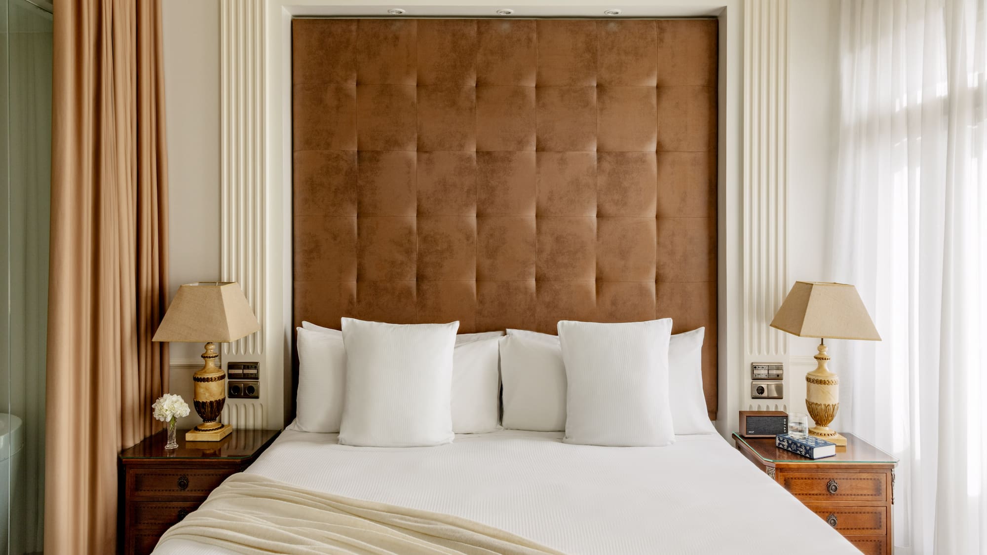 a bed with pillows and lamps in a room