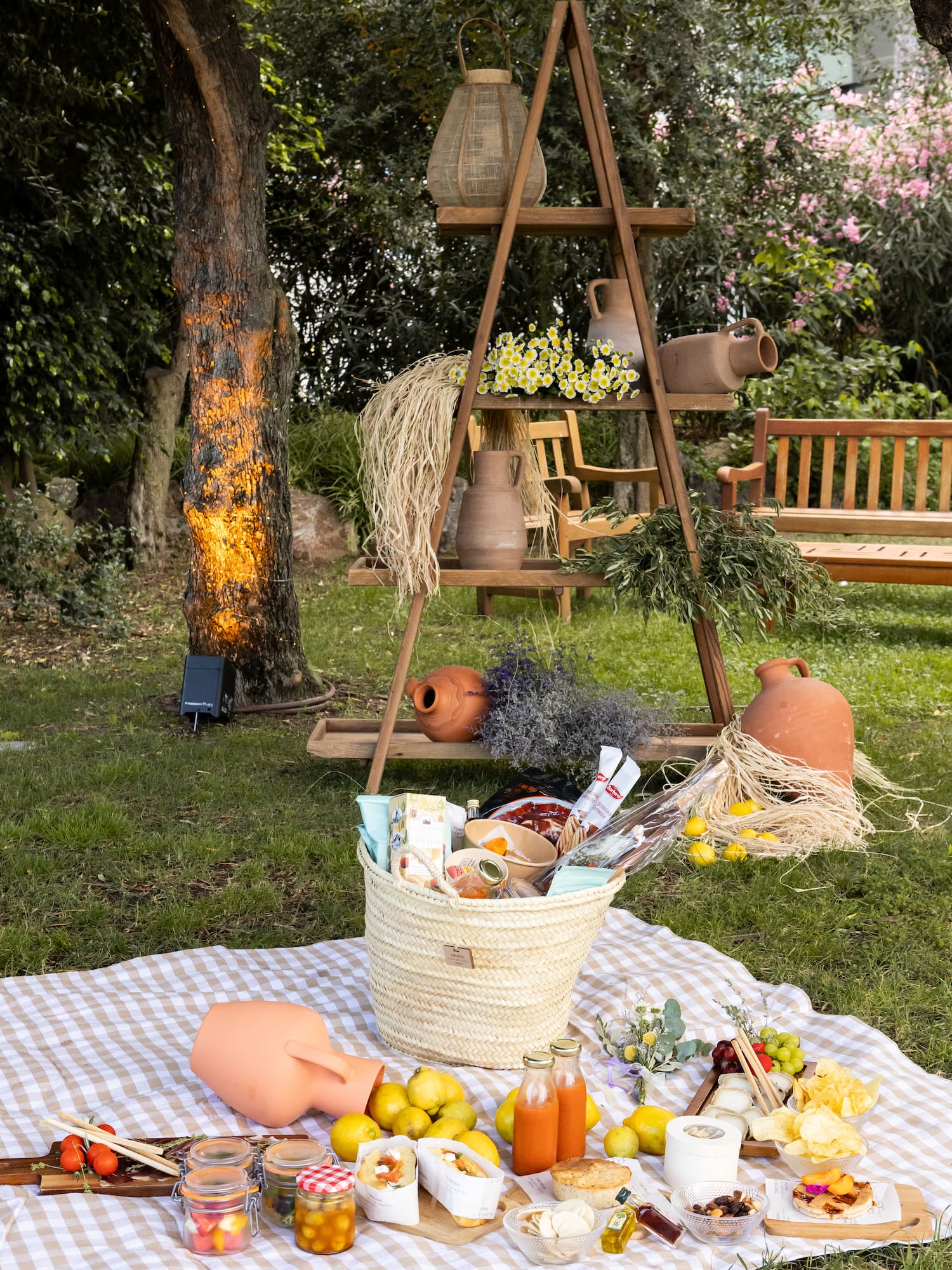 a picnic blanket with food and drinks on it