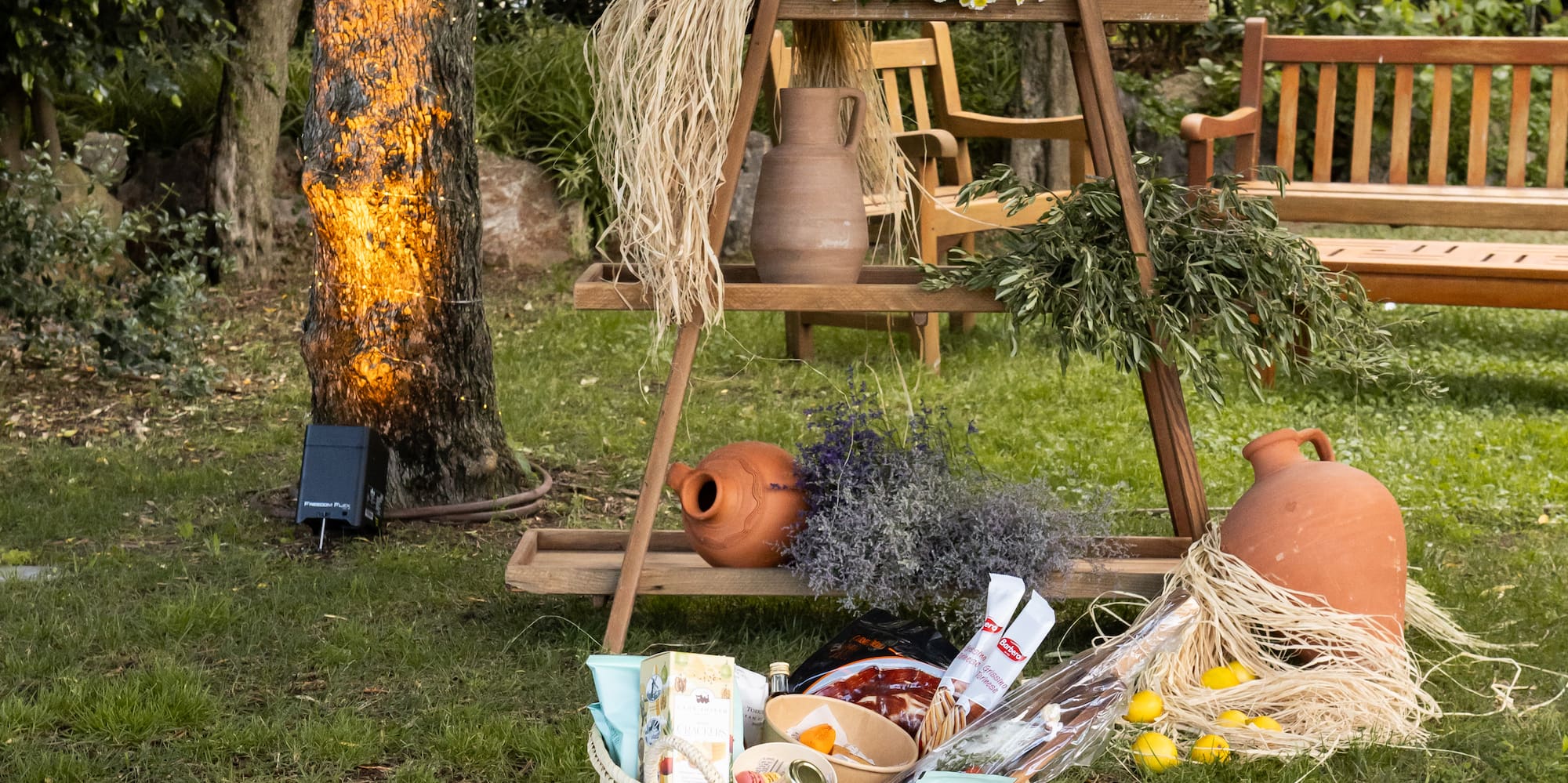 a picnic blanket with food and drinks on it