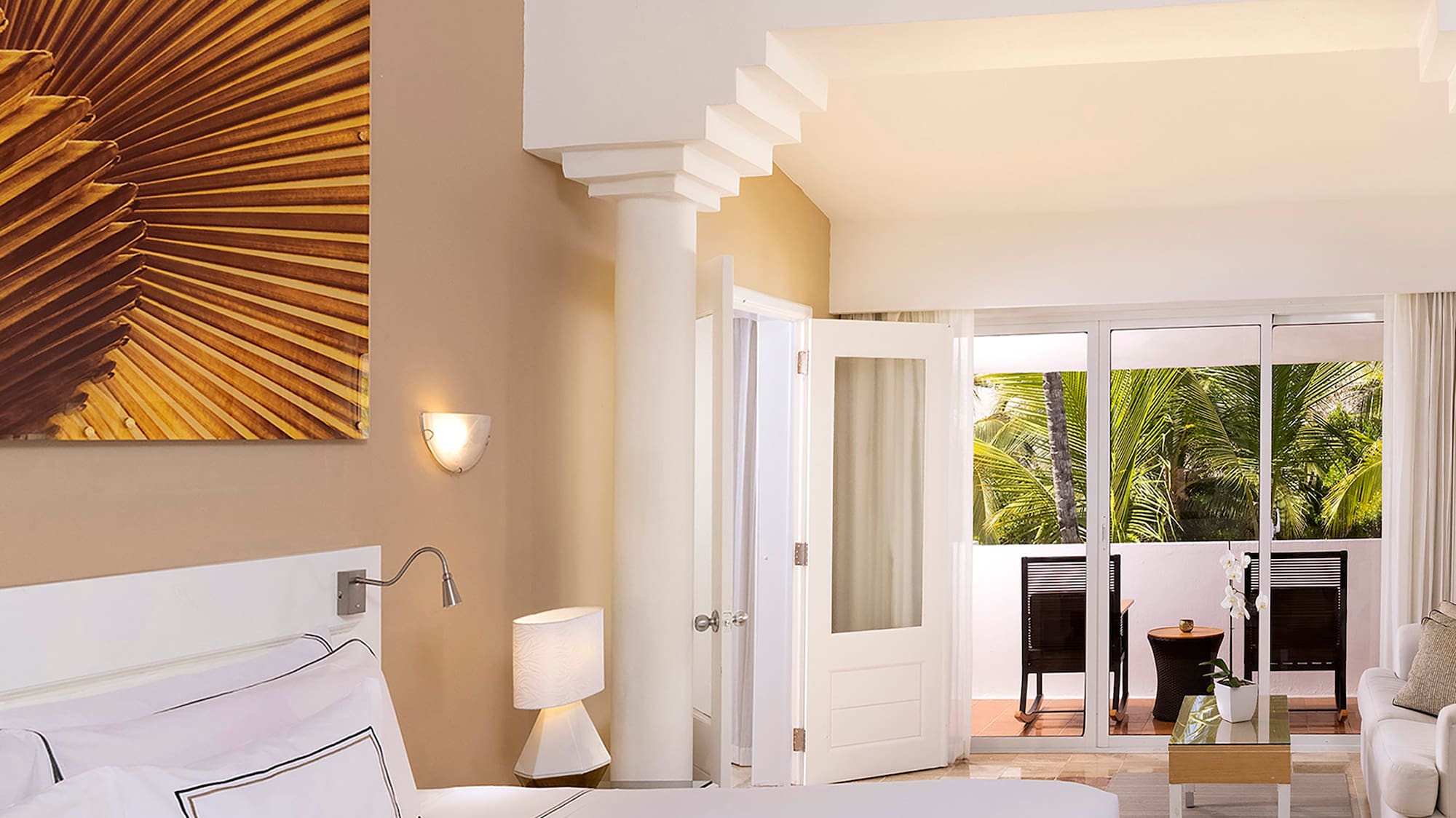 a bedroom with a large bed and a ceiling fan