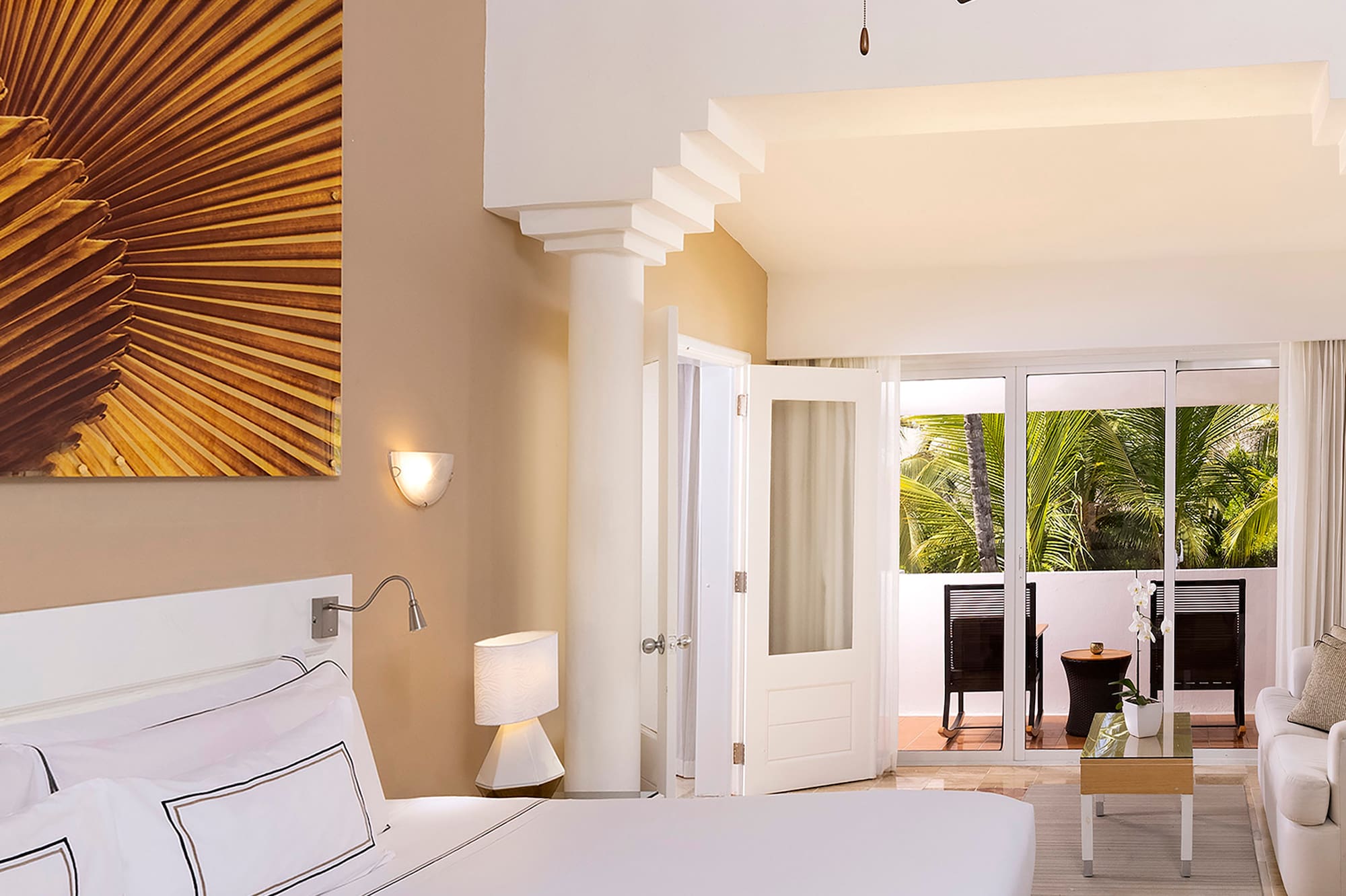 a bedroom with a large bed and a ceiling fan