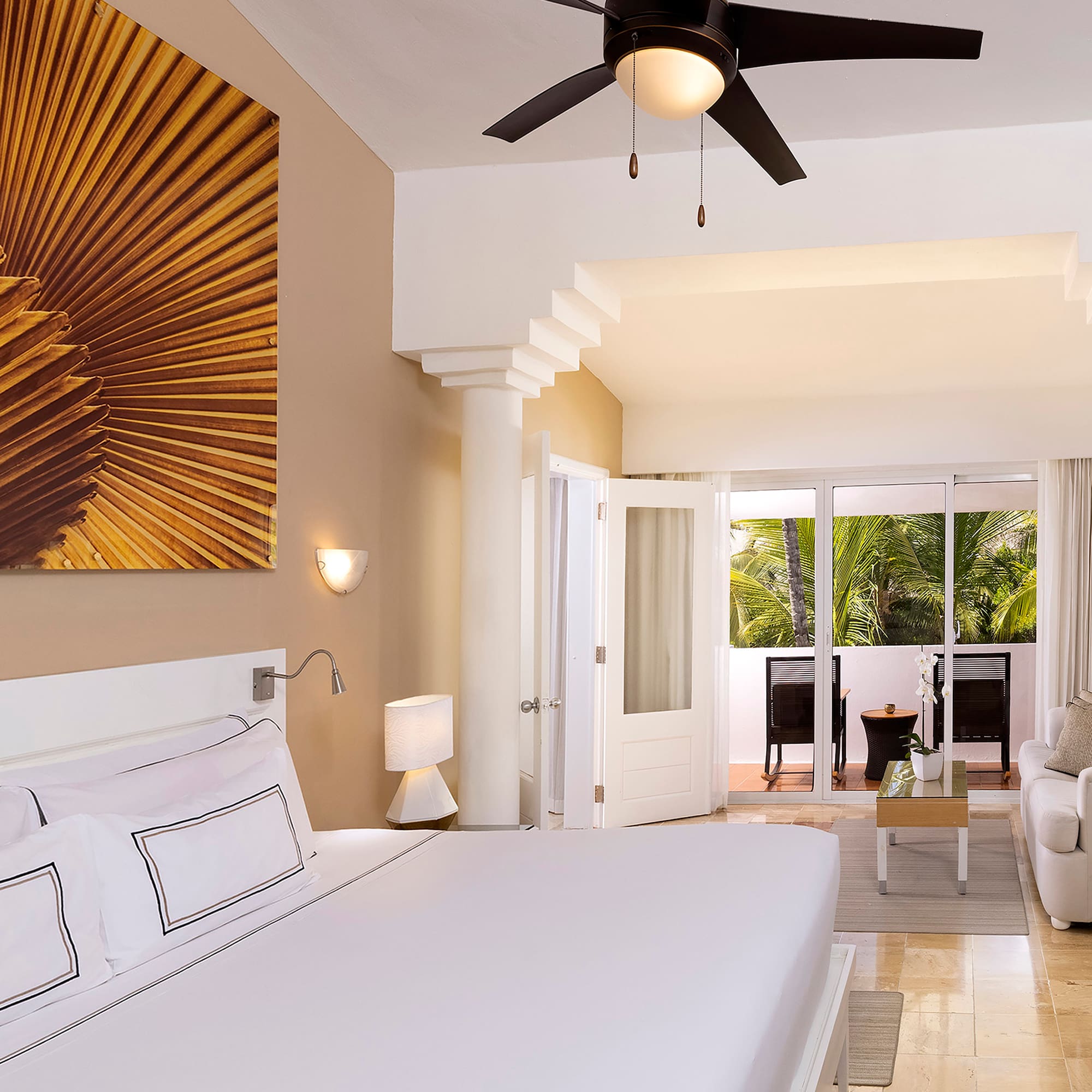 a bedroom with a large bed and a ceiling fan