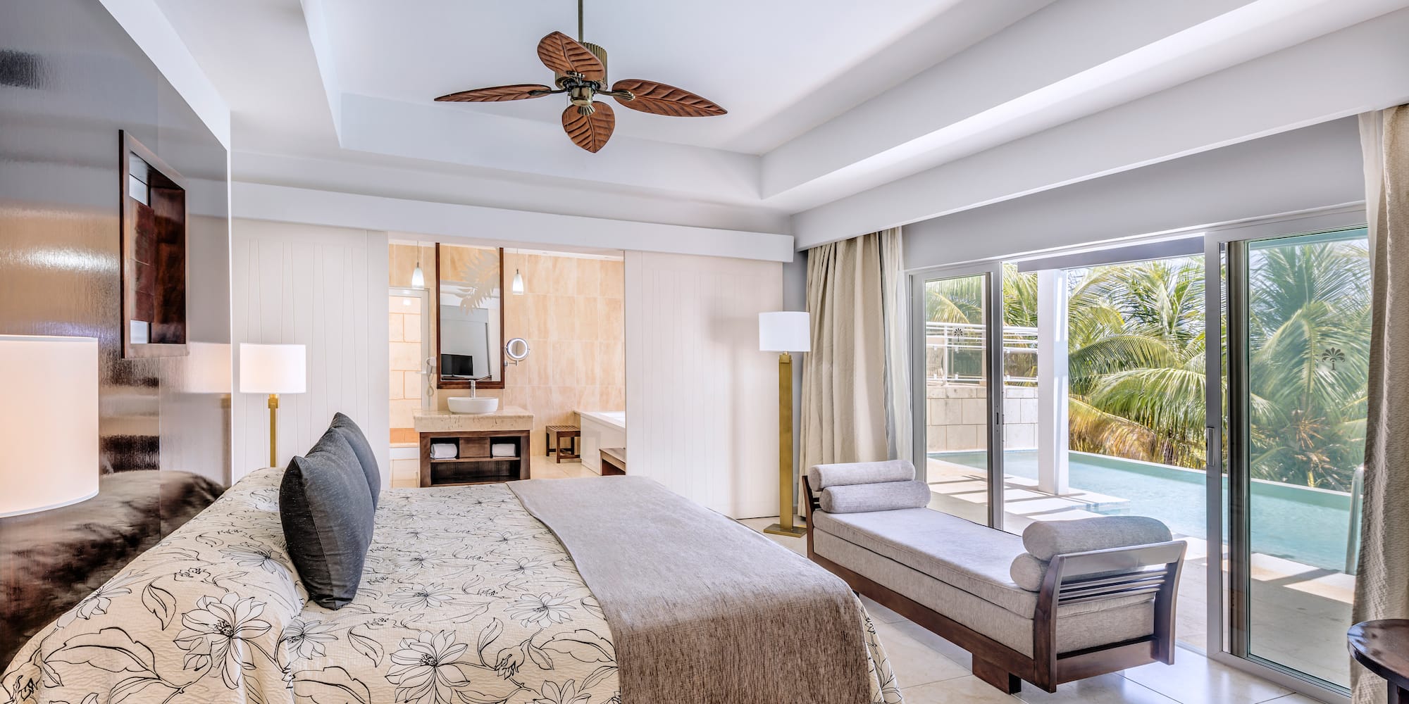 a bedroom with a bed and a pool in the background